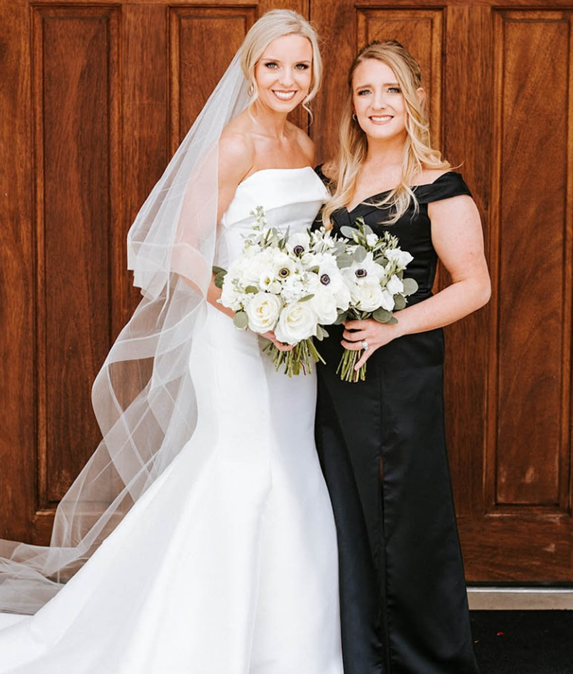 Models wearing a white and a black dresses