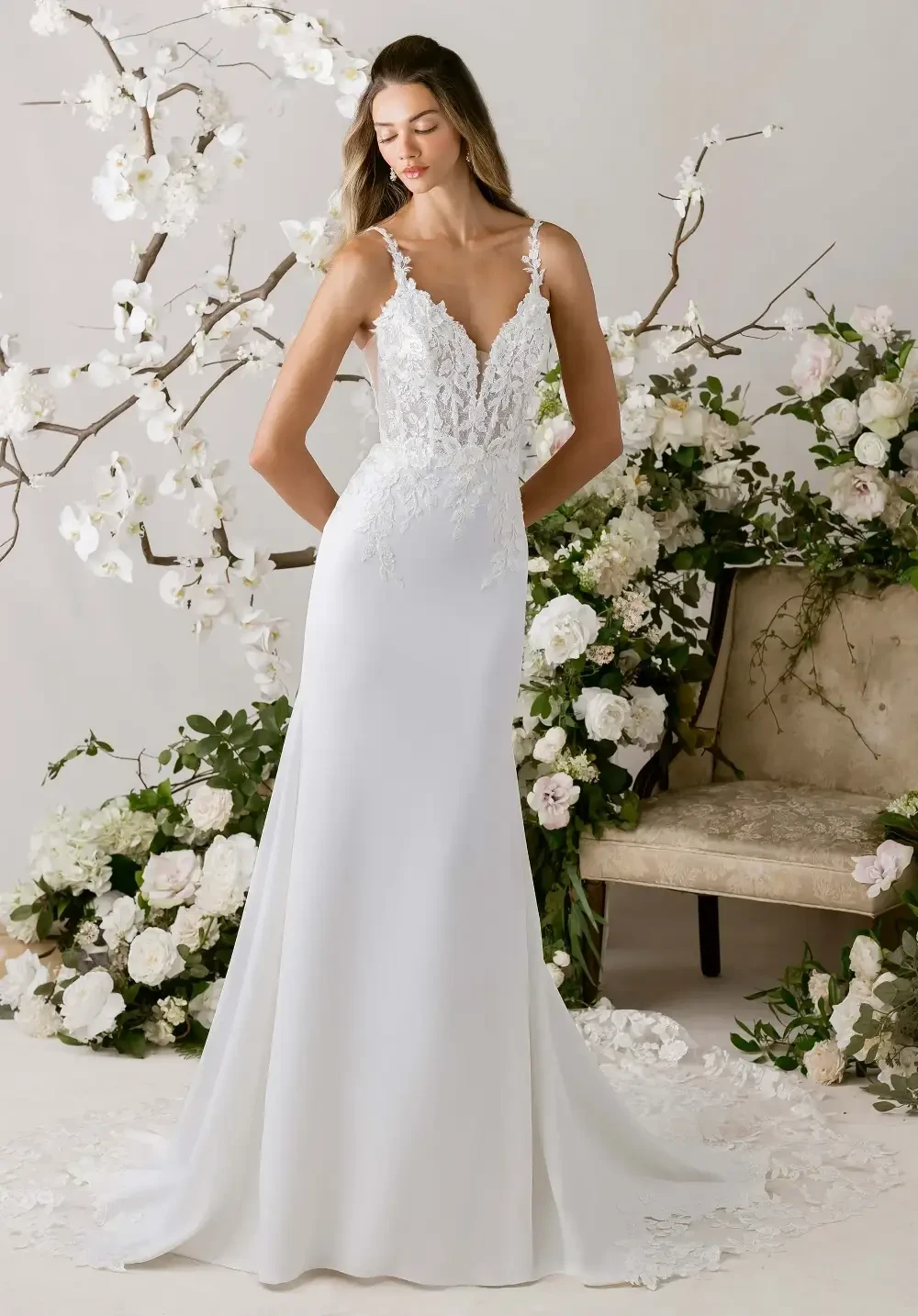 model is wearing a lace bridal gown