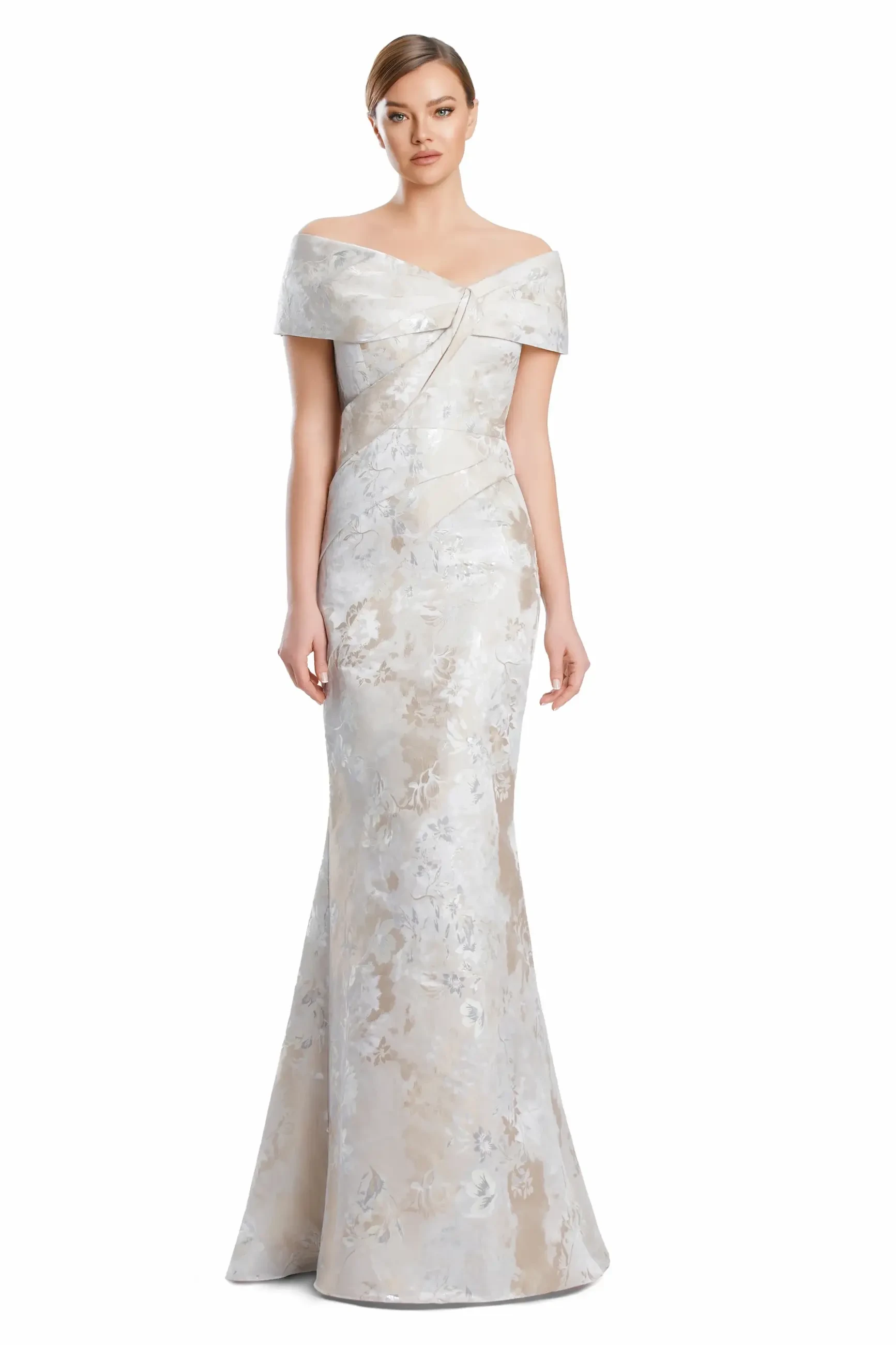 A woman in a formal, off-the-shoulder gown with a fitted silhouette and floral pattern.