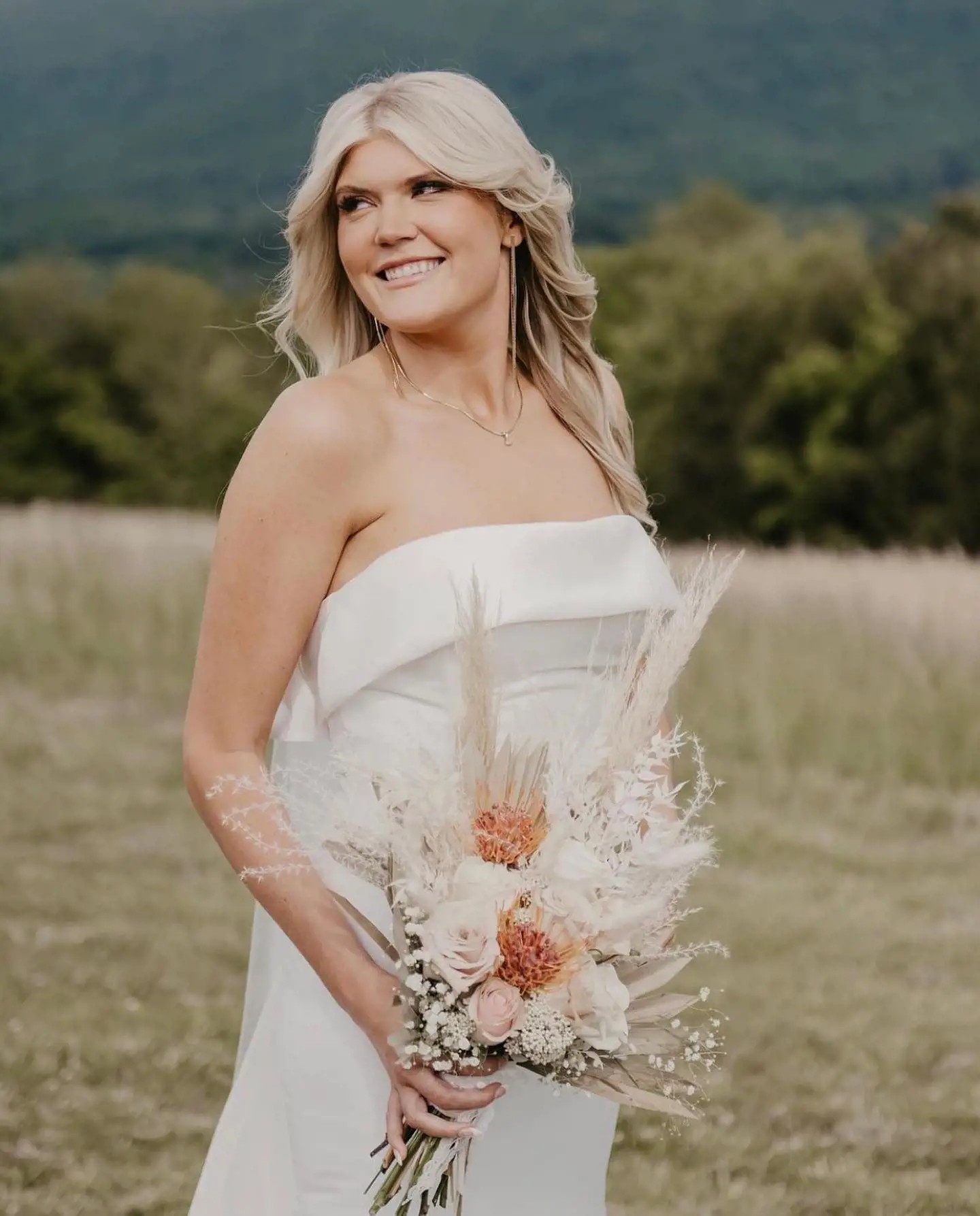 Сouple wearing a white gown and a brow suit