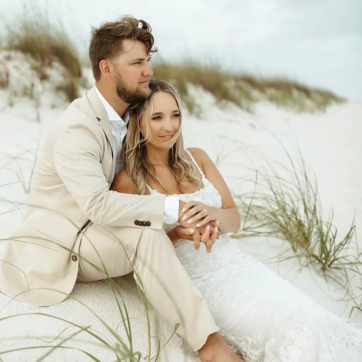 Сouple wearing a white gown and a brown suit