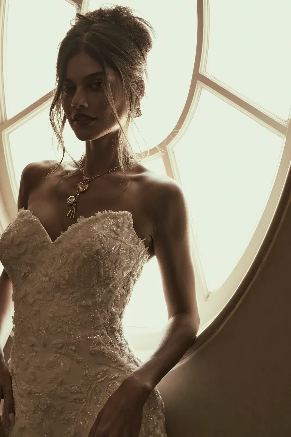 model is wearing a fitted structured strapless wedding dress