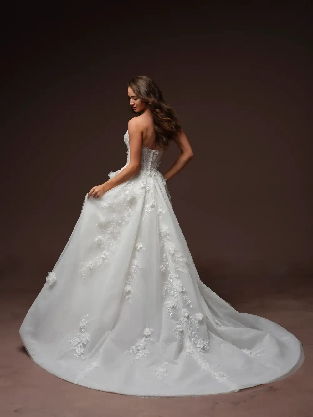 model is wearing a strapless bold ball gown wedding dress
