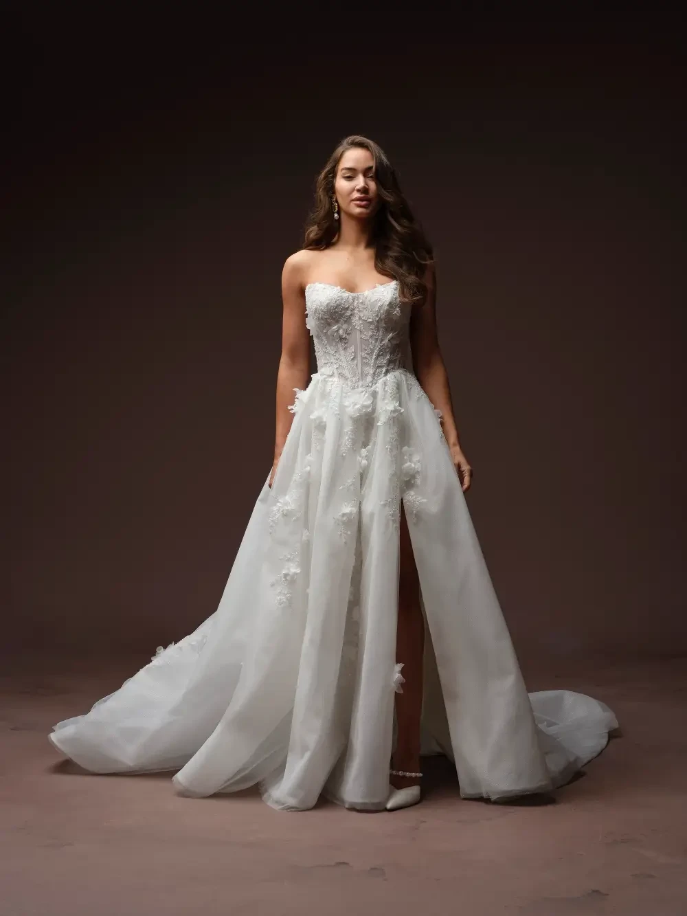 model is wearing a strapless bold ball gown wedding dress