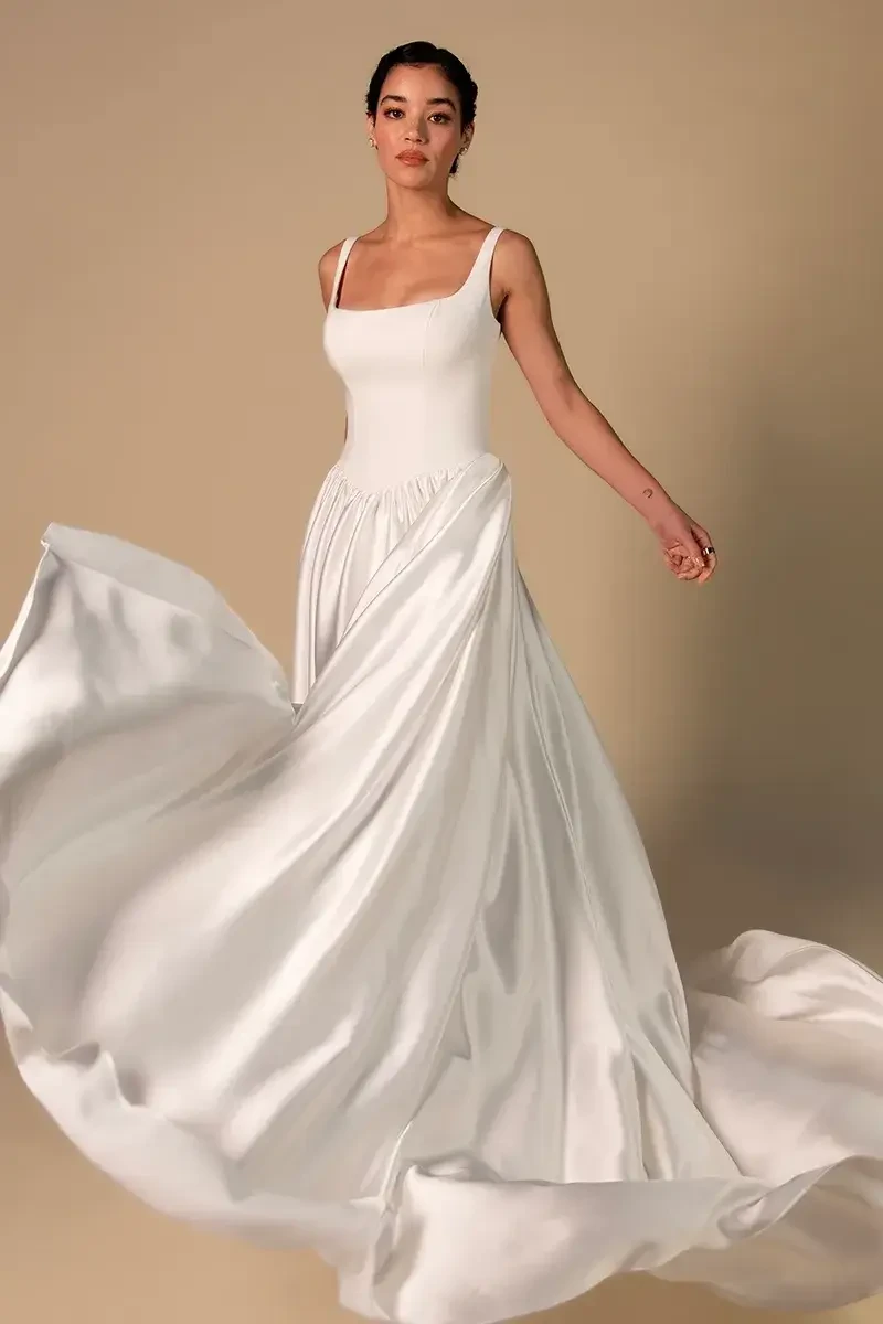 model is wearing a square neck a-line wedding dress
